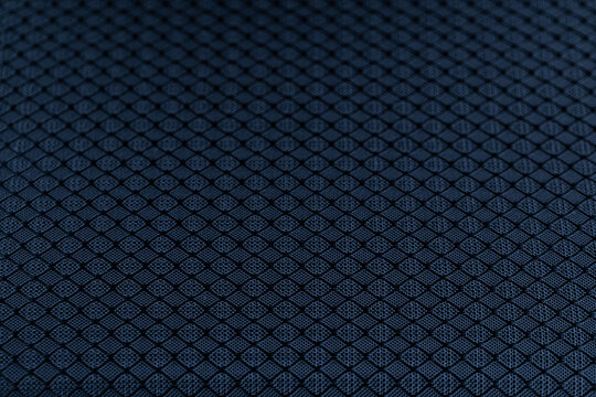 Dark blue textured nylon fabric with geometric diamond pattern macro view