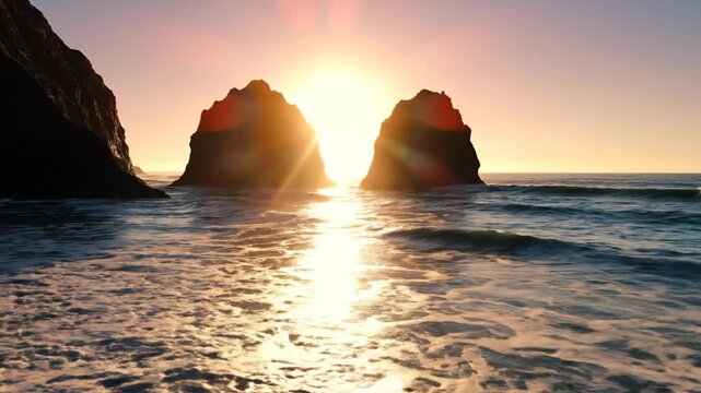 Golden sunset over coastal sea stacks with waves crashing on sandy beach