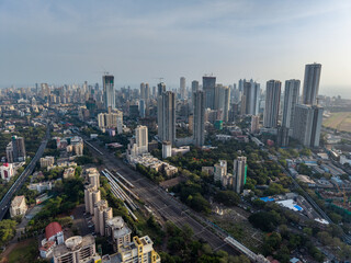 Naklejka premium Mumbai skyline and railway corridor aerial drone view India Aerial view of Mumbai cityscape with railway tracks and skyscrapers