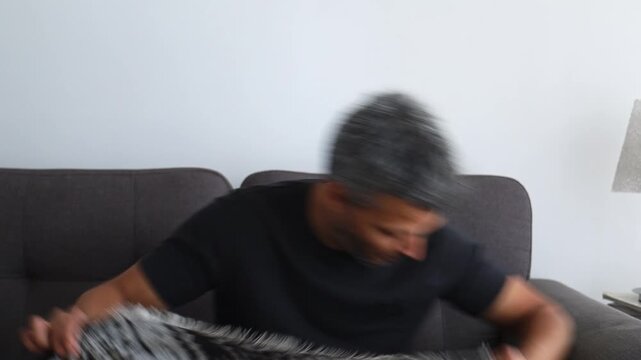 Pensive man touching face with hand feeling anxious and overwhelmed by negative thoughts at home