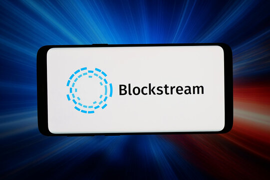 Stuttgart, Germany - 06-02-2026: In this photo illustration, the logo of blockchain technology company Blockstream is displayed on a smartphone in front of abstract background on computer screen.