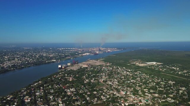 Cinematic 4K aerial dolly-in shot over the Panuco River mouth meeting the Gulf of Mexico, with Tampico, Ciudad Madero and Pueblo Viejo visible on both riverbanks