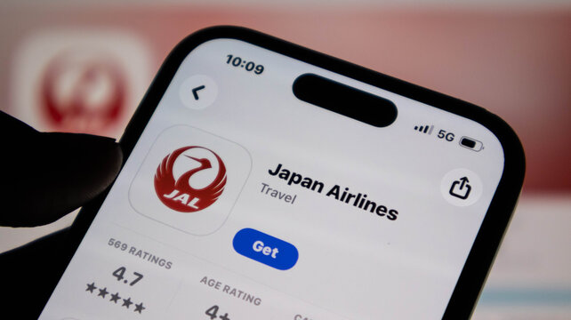 Closeup of a smartphone screen displaying the japan airlines mobile app download page in the app store