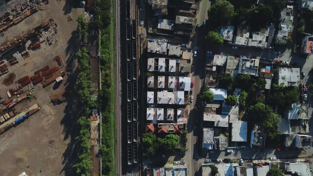 Cinematic 4K aerial drone flies forward over a main Tampico avenue at dawn, with cars in motion, residential neighborhoods and tree-lined streets visible below