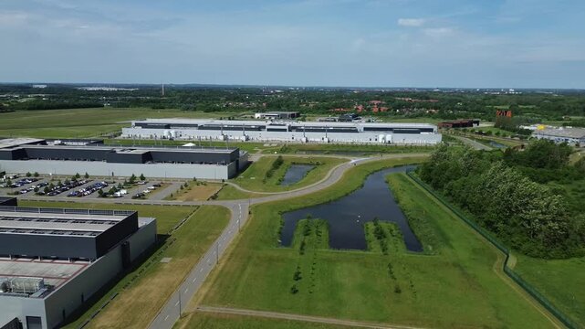 Massive modern data center facility built within the green landscape of Funen island in sunny Denmark.