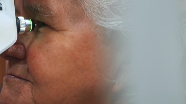 Elderly woman undergoing ophthalmic tonometer examination