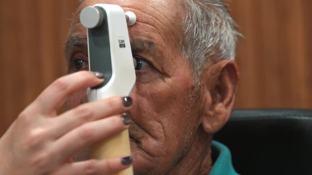 Elderly man undergoing intraocular pressure measurement test