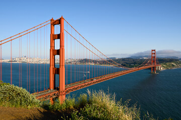 Fototapeta premium Golden Gate Bridge stretching across San Francisco Bay from a grassy Marin overlook