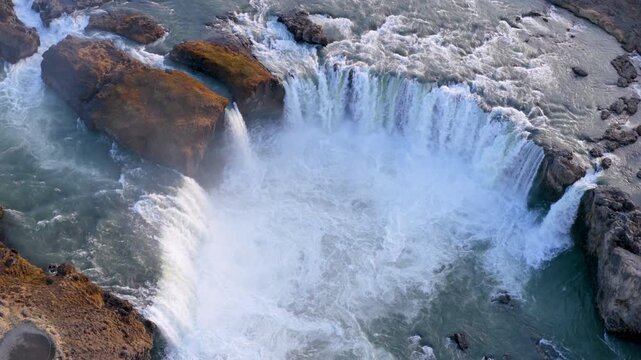 Aerial view of Powerful waterfall Godafoss pouring into a rocky basin. Iceland