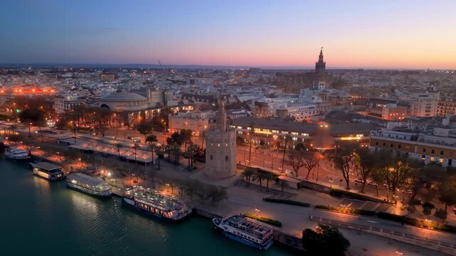 Aerial glimpse of Seville at sunset. Golden hour illuminates historic Seville city and architecture