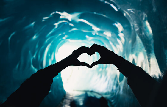 Heart shaped hands inside Mer de Glace ice cave in Chamonix Mont Blanc, France