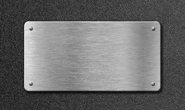 Brushed metal plaque with rivets on textured dark background for industrial signage concept