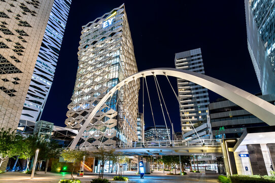 Riyadh, Saudi Arabia - February 19, 2026: Modern pedestrian arch bridge and illuminated office skyscrapers in King Abdullah Financial District at night.