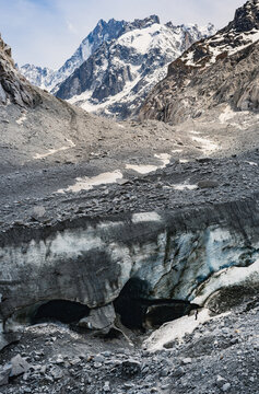Mountaineer below Mer de Glace glacier and ice cave in the French Alps