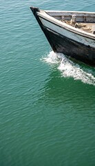 Obraz premium Fishing boat bow cutting through calm water