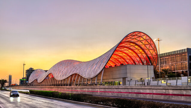 Riyadh, Saudi Arabia - February 21, 2026: The wave-shaped Ministry of Education metro station building illuminated at sunset along King Abdullah Road.