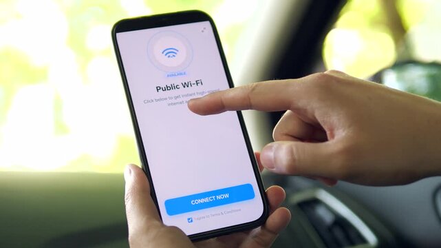 Hands holding a phone with a public Wi-Fi screen open inside a car. The display shows an available network and a blue connect button. Great for showcasing mobile internet, digital nomad life, and