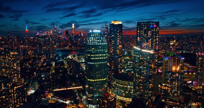 Neon illumination on the tops of skyscrapers at night. Drone footage over New Jersey with dazzling lights.