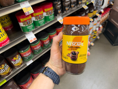 Nescafe Clasico Instant Coffee Jar Held In Hand