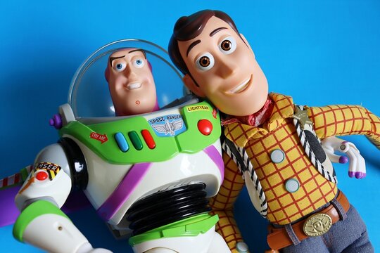 Salvador, Brazil - June 6, 2026: Sheriff Woody and Buzz Lightyear toys on a blue background. Toy Story movie and childhood toys. 
