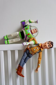 Salvador, Brazil - June 6, 2026: Buzz Lightyear toy on the headboard of a bed holding Sheriff Woody. Toy Story movie scene concept. 
