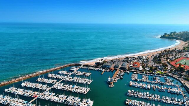 Flying over the multiple vessels at the berths in the marina. Harbor of Santa Barbara, California, USA. View on the Pacific Ocean waterscape from drone.