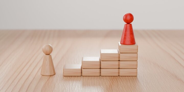 3d wooden pawn figurine looking up at another pawn placed high on building blocks. Building blocks of success, business and aspiration