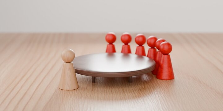 pawn figurines standing round a table, with one pawn highlighted in red. Corporate work environment, meeting, interview