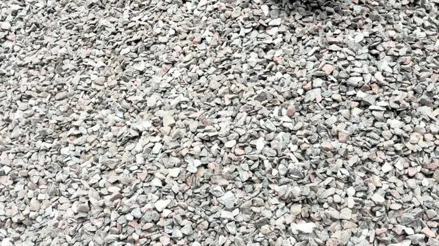 Truck unload crushed rocks. Dump truck unloads crushed stone from the body