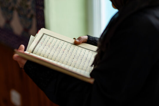 Muslim woman reading inside mosque during prayer