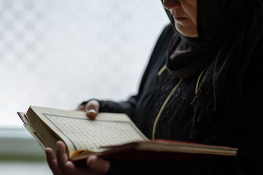 Muslim woman reading inside mosque during prayer