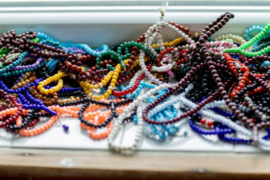 Colorful prayer beads on mosque shelf for Muslim worship