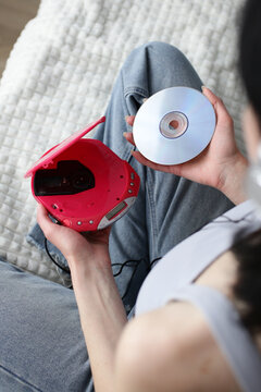 Retro portable CD player and disc in Y2K lifestyle scene