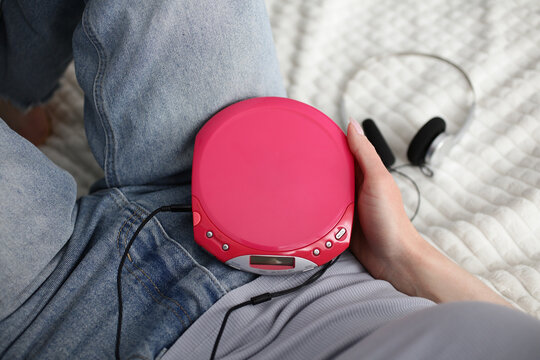Portable CD player in hand with Y2K retro audio vibes