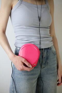 Y2K style portable CD player in hand with headphones