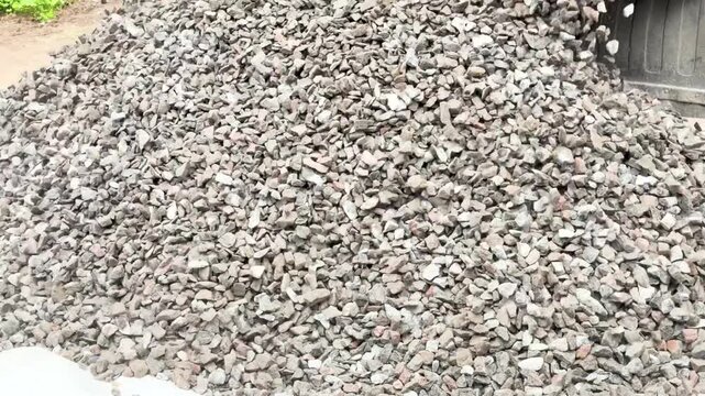 Truck unload crushed rocks. Dump truck unloads crushed stone from the body