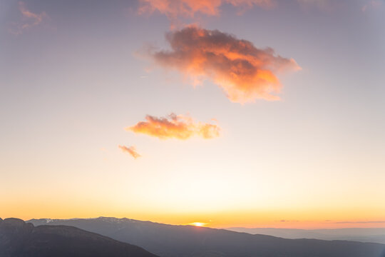 Sunset sky over Annecy with glowing cloud and mountain ridge