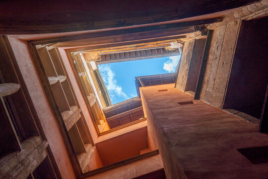 Upward view of Lyon courtyard with old walls and blue sky