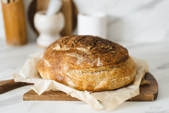 Rustic homemade sourdough bread on a wooden board
