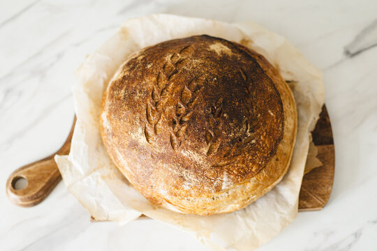 Rustic homemade sourdough bread on wooden board