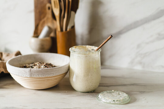 Sourdough starter and rising dough in a cozy kitchen