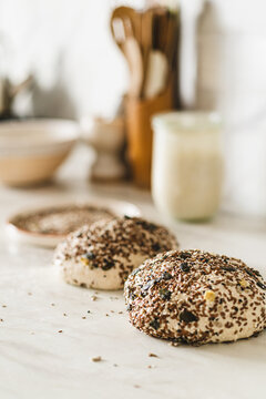 Fresh sourdough bread dough with seeds on counter