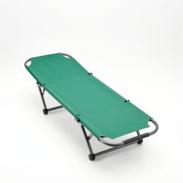 Green folding cot for outdoor activities and camping isolated on white background.