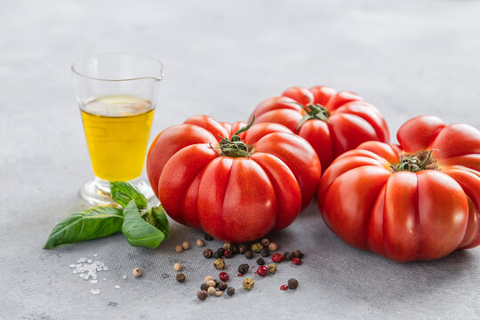 Fresh tomatoes and olive oil with peppercorns and basil
