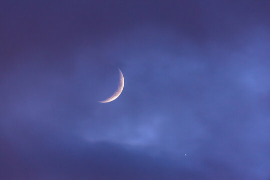 Crescent moon glowing in tranquil night sky