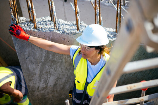 Female construction worker in hard hat at building site