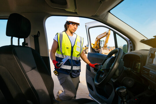 Female construction worker entering site vehicle at work