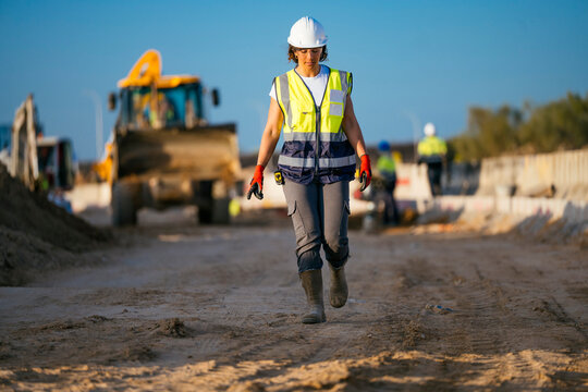 Female construction worker in hard hat at site for safety