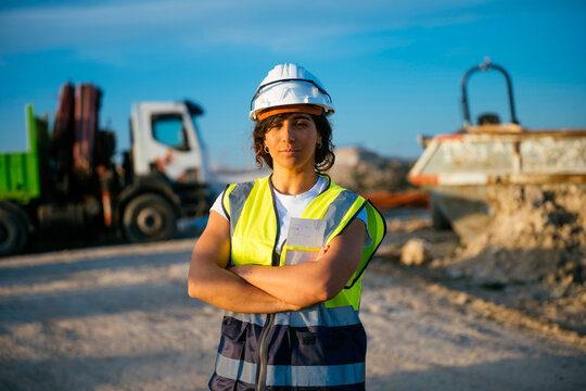 Female construction worker wearing hard hat at worksite