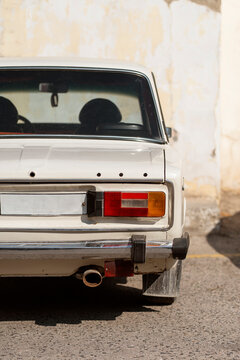 Rear view of vintage Soviet car in urban sunlight